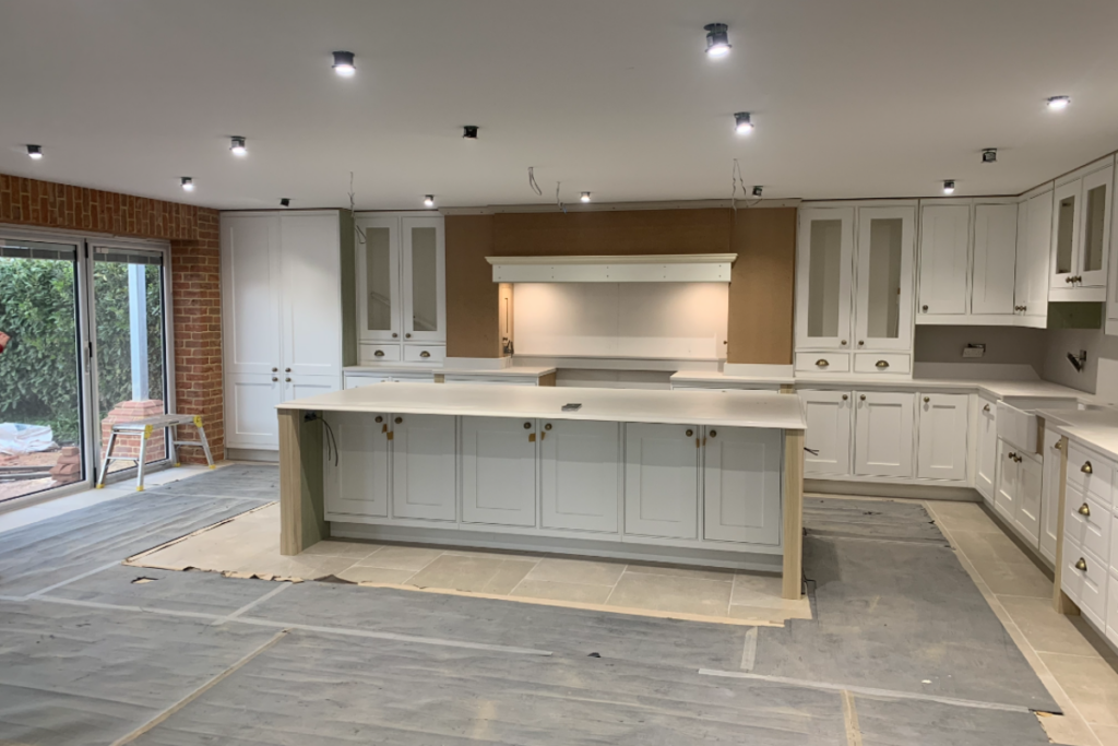 A bright kitchen featuring white cabinets and a spacious island, perfect for cooking and entertaining.