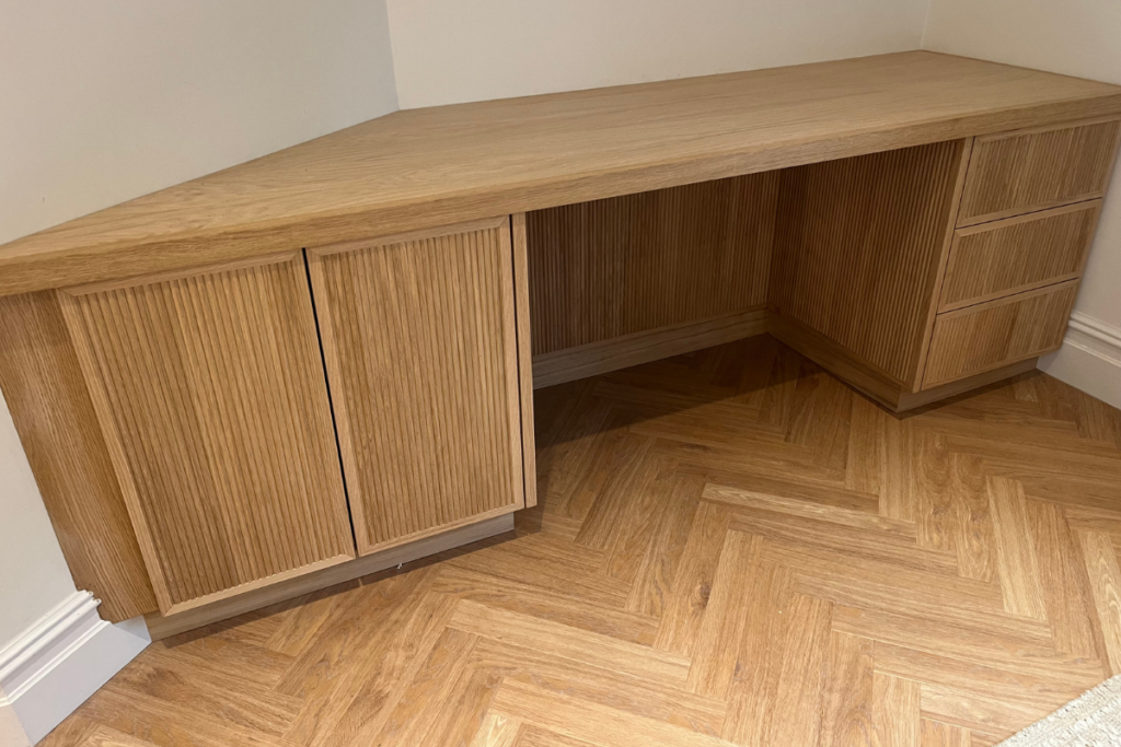 A corner desk featuring multiple drawers and cabinets, designed for efficient workspace organization and storage.