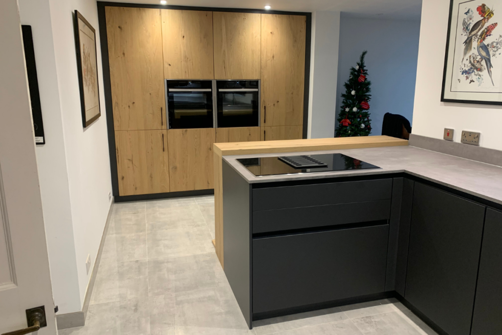 A modern kitchen featuring sleek black cabinets and a stylish countertop, creating a contemporary and elegant atmosphere.