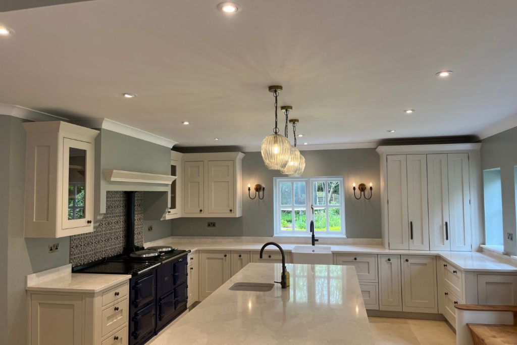 A spacious kitchen featuring a large island and elegant white cabinets, creating a bright and inviting atmosphere.