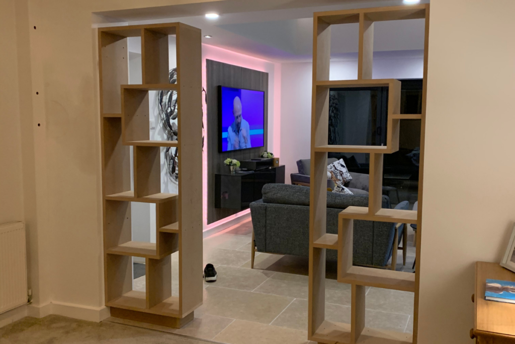 A cozy living room featuring a television and a well-stocked bookcase, creating a welcoming atmosphere for relaxation.