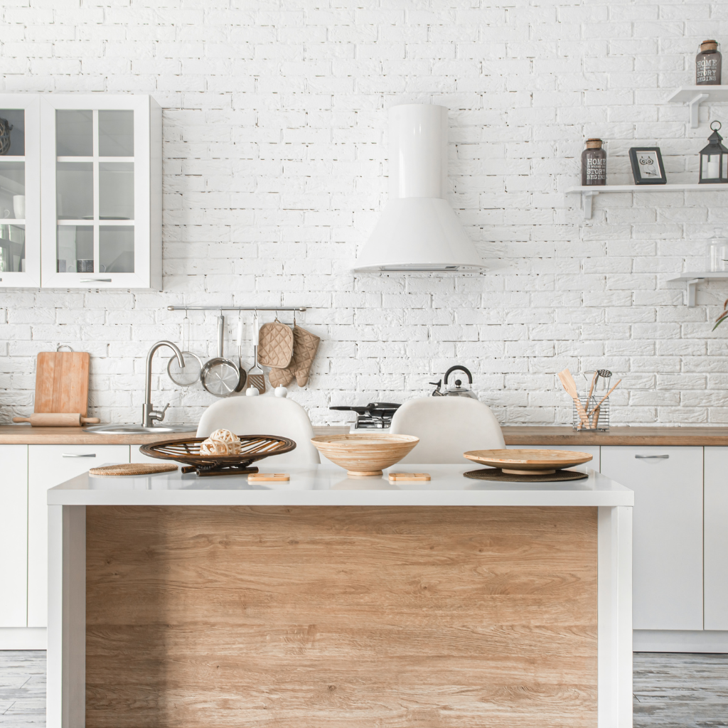 A modern kitchen featuring white brick walls and a stylish wooden island, creating a warm and inviting atmosphere.