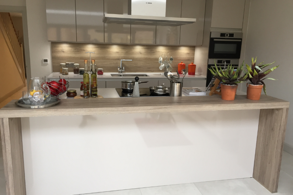 A modern kitchen featuring a white countertop and a sleek sink, creating a bright and clean cooking space.